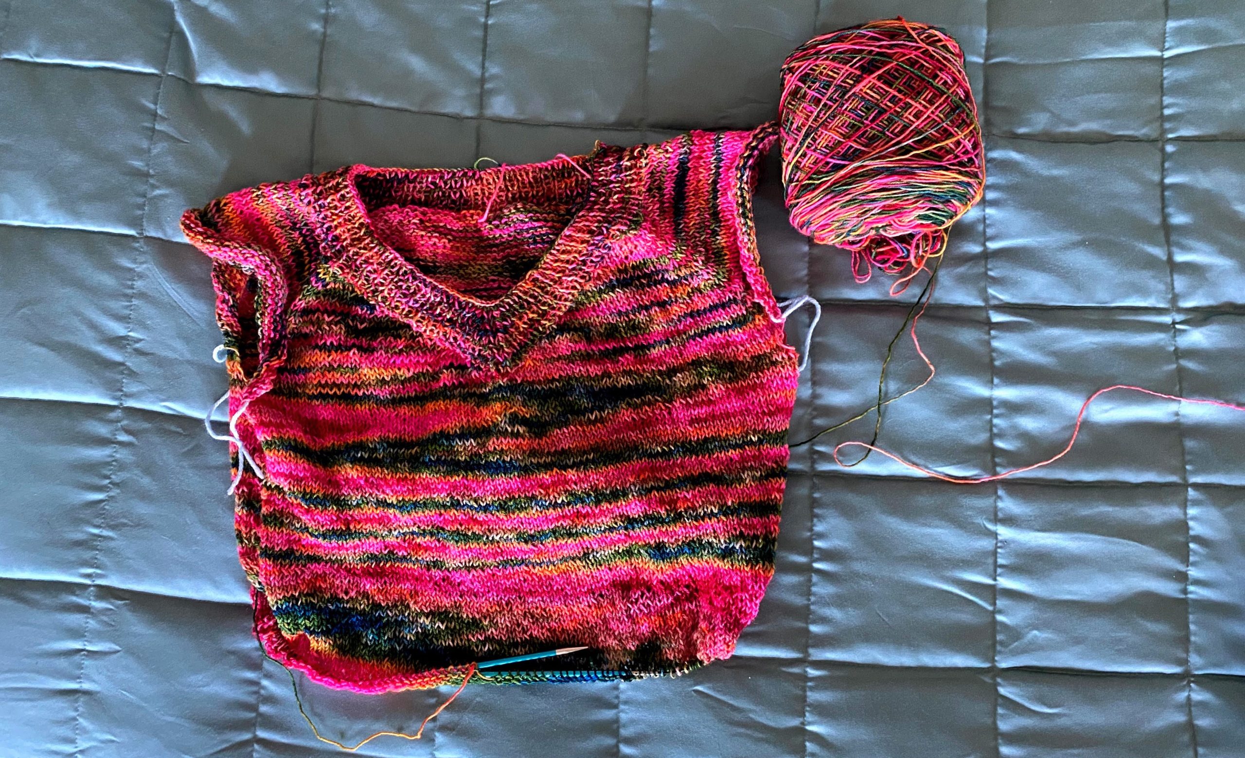 A brightly colored partially finished sweater